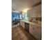 Bright kitchen with white cabinets, stainless steel dishwasher, and tile flooring at 300 N 22Nd St, Bradenton Beach, FL 34217