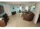 Bright living room featuring tile flooring, a large sofa, and access to the dining and kitchen areas at 300 N 22Nd St, Bradenton Beach, FL 34217