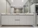 Sleek bathroom vanity with dual sinks, bright lighting, and minimalist design at 301 Quay Commons # 1709, Sarasota, FL 34236