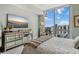 Cozy bedroom with city views showcases a mirrored dresser and luxury decor at 301 Quay Commons # 1709, Sarasota, FL 34236
