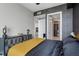 Stylish bedroom featuring a decorative accent wall, modern furniture, and an open doorway at 301 Quay Commons # 1709, Sarasota, FL 34236