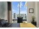 Modern bedroom featuring stylish decor, a sleek desk, and a large window with an inviting city view at 301 Quay Commons # 1709, Sarasota, FL 34236