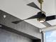 Contemporary ceiling fan with curved blades against textured wallpaper and a bright window at 301 Quay Commons # 1709, Sarasota, FL 34236