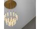 Close up of a modern chandelier with unique gold accents at 301 Quay Commons # 1709, Sarasota, FL 34236