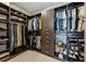 Custom walk-in closet with ample storage, well-organized hanging space, shelving, and drawers at 301 Quay Commons # 1709, Sarasota, FL 34236