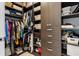 Organized walk-in closet provides ample storage space with shelving and hanging racks at 301 Quay Commons # 1709, Sarasota, FL 34236