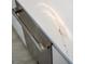 Close-up of kitchen countertop showing marble pattern and stainless steel dishwasher at 301 Quay Commons # 1709, Sarasota, FL 34236