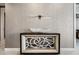 Entryway features decorative table with modern art piece, a unique wall light, and neutral color palette at 301 Quay Commons # 1709, Sarasota, FL 34236