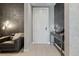 Inviting hallway featuring stylish decor, a modern console table, and a cozy seating area at 301 Quay Commons # 1709, Sarasota, FL 34236