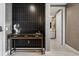 Contemporary hallway features a decorative console table and leads to a bathroom at 301 Quay Commons # 1709, Sarasota, FL 34236