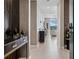 Elegant hallway with stylish console table, patterned wall decor, and tiled flooring at 301 Quay Commons # 1709, Sarasota, FL 34236