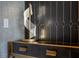 Close up on a modern console table with stylish lamp and decorative wall tiles in a hallway at 301 Quay Commons # 1709, Sarasota, FL 34236