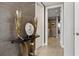 Hallway featuring a decorative table with gold accents and view into the bathroom at 301 Quay Commons # 1709, Sarasota, FL 34236