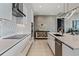 Contemporary kitchen featuring sleek white cabinetry and modern appliances at 301 Quay Commons # 1709, Sarasota, FL 34236