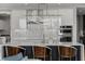 Stylish kitchen features white cabinets, stainless steel appliances, and an island with bar seating at 301 Quay Commons # 1709, Sarasota, FL 34236