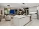 Open-concept kitchen with center island, stainless steel appliances, and adjacent living area at 301 Quay Commons # 1709, Sarasota, FL 34236