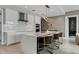 Modern kitchen with an island, bar stools, and stainless steel appliances at 301 Quay Commons # 1709, Sarasota, FL 34236