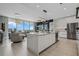 Open-concept kitchen with center island, stainless steel appliances, and bright living space at 301 Quay Commons # 1709, Sarasota, FL 34236