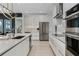 Contemporary kitchen with white cabinetry, stainless steel appliances, and sleek countertops at 301 Quay Commons # 1709, Sarasota, FL 34236