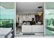 Open living room and kitchen area with modern furnishings and a beautiful water view from the balcony at 301 Quay Commons # 1709, Sarasota, FL 34236
