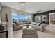 Spacious living room with floor-to-ceiling windows offering stunning water views and ample seating at 301 Quay Commons # 1709, Sarasota, FL 34236