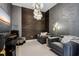 Modern living room features unique wall textures, stylish lighting, and comfortable seating at 301 Quay Commons # 1709, Sarasota, FL 34236