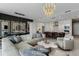 Open-concept living space features kitchen with bar seating and dining table at 301 Quay Commons # 1709, Sarasota, FL 34236