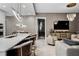 Open-concept living space with modern decor, including sleek lighting, TV, and comfortable seating at 301 Quay Commons # 1709, Sarasota, FL 34236