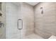 Modern walk-in shower with sleek fixtures, glass door, and neutral tile at 301 Quay Commons # 1709, Sarasota, FL 34236