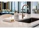 Modern kitchen sink with stylish fixtures on countertop at 301 Quay Commons # 1709, Sarasota, FL 34236