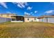 Wide backyard with a screened in porch and white vinyl fence at 309 Blue Point Dr, Ruskin, FL 33570