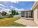 Spacious backyard featuring a screened-in patio and a well-maintained lawn at 309 Blue Point Dr, Ruskin, FL 33570