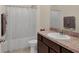 Well-lit bathroom featuring a shower with curtain, a sink with a modern faucet, and neutral color scheme at 309 Blue Point Dr, Ruskin, FL 33570