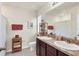 Bathroom featuring double sinks with granite countertops, wooden cabinets, and a large mirror at 309 Blue Point Dr, Ruskin, FL 33570