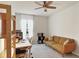 Bright bedroom featuring a ceiling fan, neutral walls, and a cozy seating area at 309 Blue Point Dr, Ruskin, FL 33570