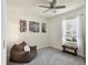Simple bedroom features a comfortable beanbag chair, bench seating by the window and neutral colored carpet at 309 Blue Point Dr, Ruskin, FL 33570