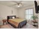 Serene bedroom with natural light, ceiling fan, neutral colors and a comfortable bed at 309 Blue Point Dr, Ruskin, FL 33570