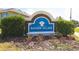 Bayside Village entrance sign with decorative stone and lush landscaping at 309 Blue Point Dr, Ruskin, FL 33570