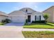 Charming single-story home features a well-manicured lawn and attached two-car garage at 309 Blue Point Dr, Ruskin, FL 33570