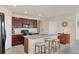 Well-lit kitchen featuring dark cabinetry, granite countertops, an island with bar seating, and stainless steel appliances at 309 Blue Point Dr, Ruskin, FL 33570