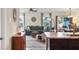Open-concept living space with sectional sofa, large windows, and connected dining area at 309 Blue Point Dr, Ruskin, FL 33570