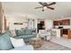 Open-concept living room boasts ample natural light, a ceiling fan, and flows into the kitchen and dining areas at 309 Blue Point Dr, Ruskin, FL 33570