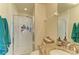 Bathroom featuring granite countertops, a glass-enclosed shower, and modern fixtures at 311 Cape Harbour Loop # 108, Bradenton, FL 34212