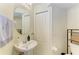 Well-maintained bathroom with a pedestal sink, storage closet, and ample lighting at 311 Cape Harbour Loop # 108, Bradenton, FL 34212