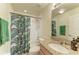 Bathroom featuring a shower-tub combination, green shower curtain, and granite countertop at 311 Cape Harbour Loop # 108, Bradenton, FL 34212
