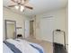Bright bedroom with a ceiling fan, double closet doors, and a nearby treadmill at 311 Cape Harbour Loop # 108, Bradenton, FL 34212
