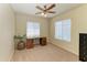 Bedroom with neutral carpet featuring a ceiling fan, window, and desk at 311 Cape Harbour Loop # 108, Bradenton, FL 34212
