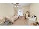 Cozy bedroom featuring a ceiling fan, window, and neutral carpet at 311 Cape Harbour Loop # 108, Bradenton, FL 34212