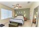 Comfortable bedroom featuring a large window, ceiling fan, and stylish decor at 311 Cape Harbour Loop # 108, Bradenton, FL 34212