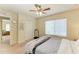 Bright bedroom featuring a ceiling fan, large window, and neutral carpet at 311 Cape Harbour Loop # 108, Bradenton, FL 34212